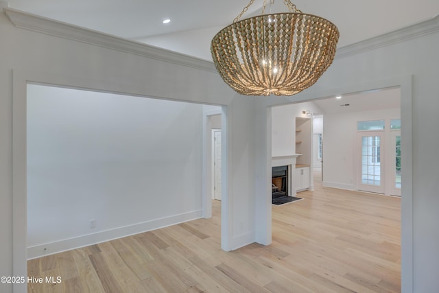 226 Bayfield Dr, Wilmington, NC 28411 - unfurnished dining area featuring a chandelier, crown molding, wood finished floors, recessed lighting, and a fireplace with flush hearth