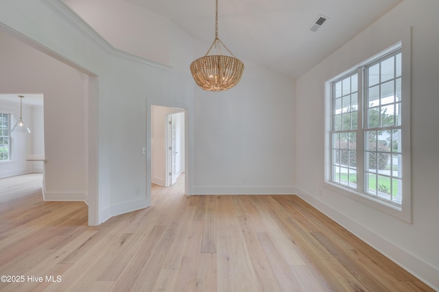 226 Bayfield Dr, Wilmington, NC 28411 - empty room featuring healthy amount of natural light, a chandelier, light wood-style floors, and high vaulted ceiling