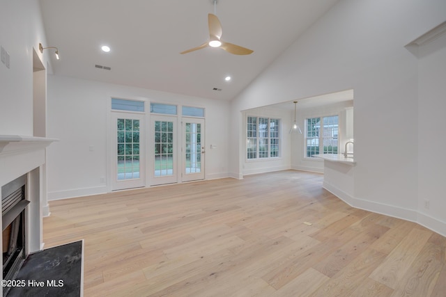 226 Bayfield Dr, Wilmington, NC 28411 - unfurnished living room with a fireplace, a ceiling fan, light wood-style floors, high vaulted ceiling, and recessed lighting