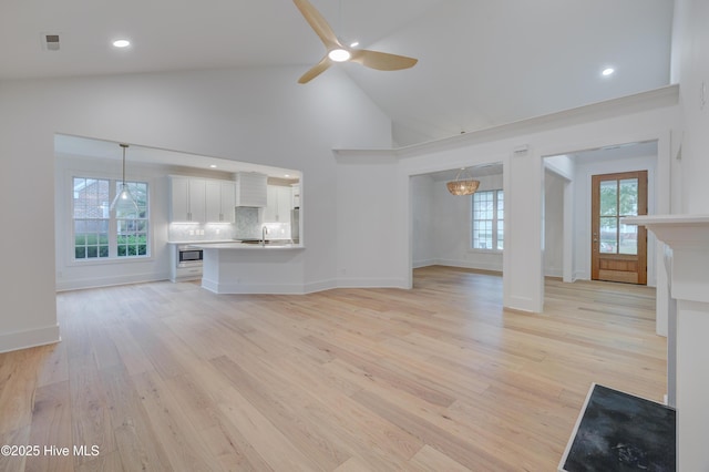 226 Bayfield Dr, Wilmington, NC 28411 - unfurnished living room with light wood finished floors, a ceiling fan, high vaulted ceiling, and recessed lighting