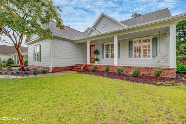 226 Bayfield Dr, Wilmington, NC 28411 - view of front facade with roof with shingles, a front yard, and covered porch