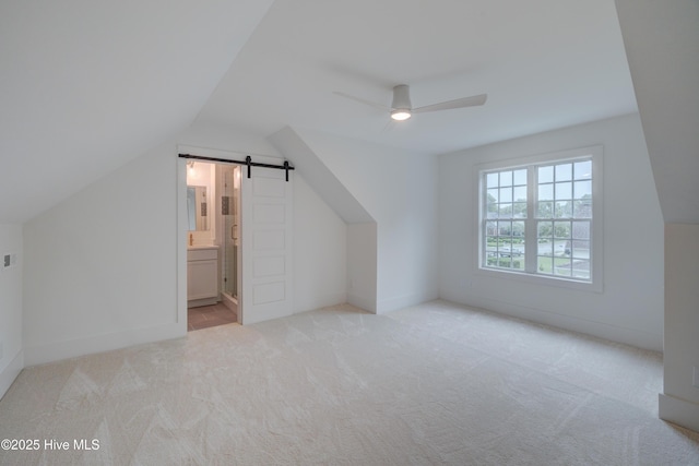 226 Bayfield Dr, Wilmington, NC 28411 - additional living space with ceiling fan, carpet flooring, a barn door, and lofted ceiling