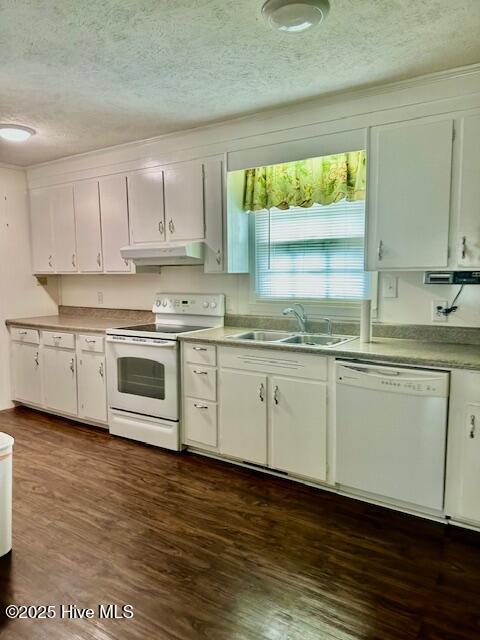 kitchen with white appliances, dark wood-type flooring, white cabinetry, under cabinet range hood, and a sink