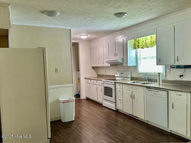 kitchen with a sink, white appliances, a textured ceiling, dark wood-style floors, and under cabinet range hood