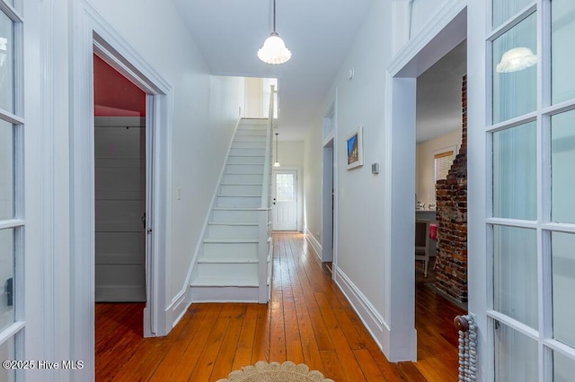 411 Queen St, New Bern, NC 28560 - hallway with baseboards, stairway, and hardwood / wood-style floors