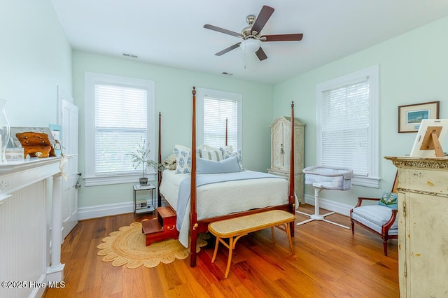 411 Queen St, New Bern, NC 28560 - bedroom with baseboards, a ceiling fan, wood finished floors, and visible vents