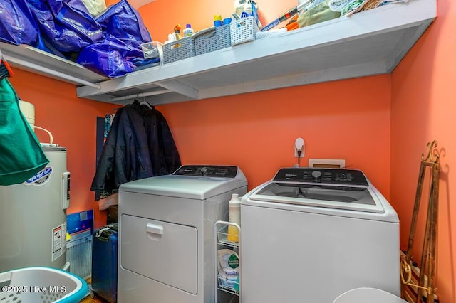 411 Queen St, New Bern, NC 28560 - washroom featuring laundry area, water heater, washing machine and dryer, and wood finished floors