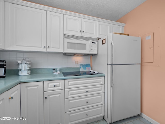 kitchen featuring tasteful backsplash, white cabinets, and white appliances