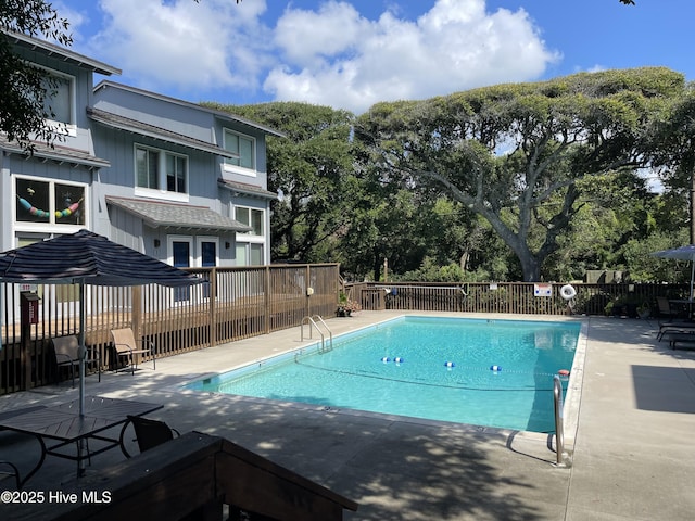 pool featuring a patio area and fence