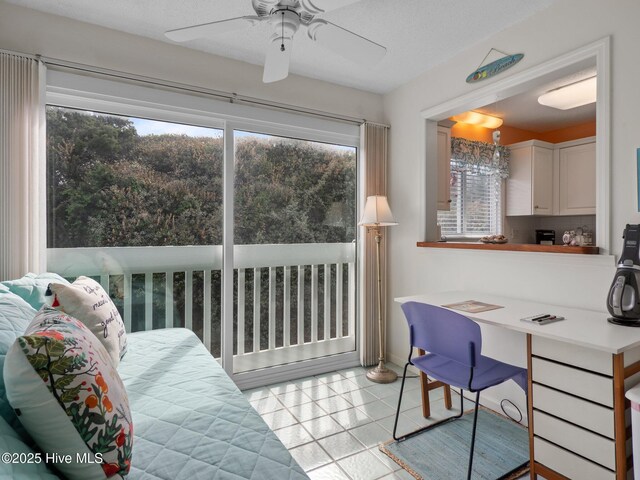 interior space featuring light tile patterned floors, ceiling fan, and plenty of natural light
