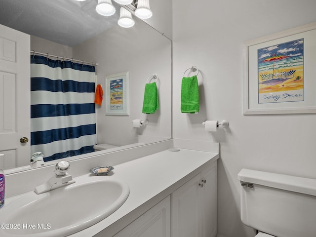 bathroom with vanity, toilet, and a shower with curtain