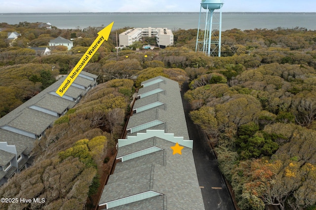 aerial view with a water view and a forest view