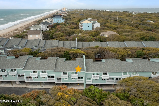 birds eye view of property featuring a beach view and a water view