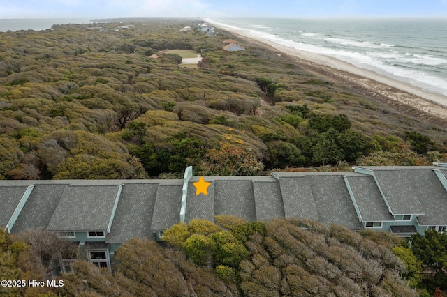 birds eye view of property with a water view and a view of the beach