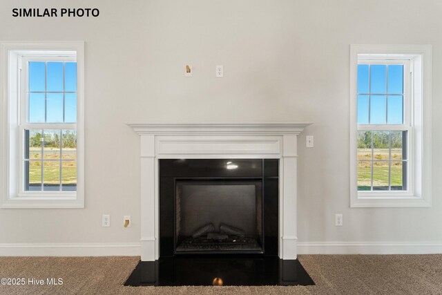 608 Indigo Johnston Dr, Jacksonville, NC 28546 - interior details with a fireplace with flush hearth, carpet flooring, and baseboards