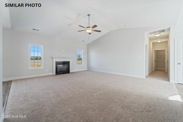 608 Indigo Johnston Dr, Jacksonville, NC 28546 - unfurnished living room featuring visible vents, a ceiling fan, light colored carpet, and vaulted ceiling