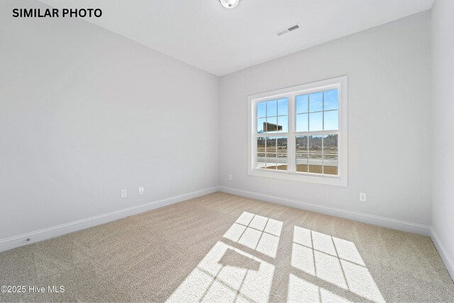 608 Indigo Johnston Dr, Jacksonville, NC 28546 - spare room featuring light carpet, visible vents, and baseboards