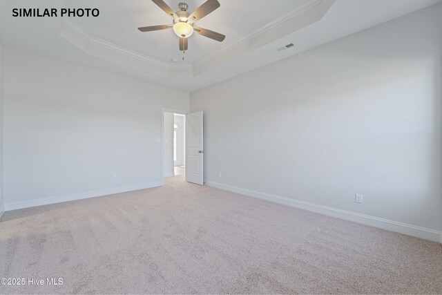 608 Indigo Johnston Dr, Jacksonville, NC 28546 - unfurnished room featuring crown molding, ceiling fan, carpet, a tray ceiling, and baseboards