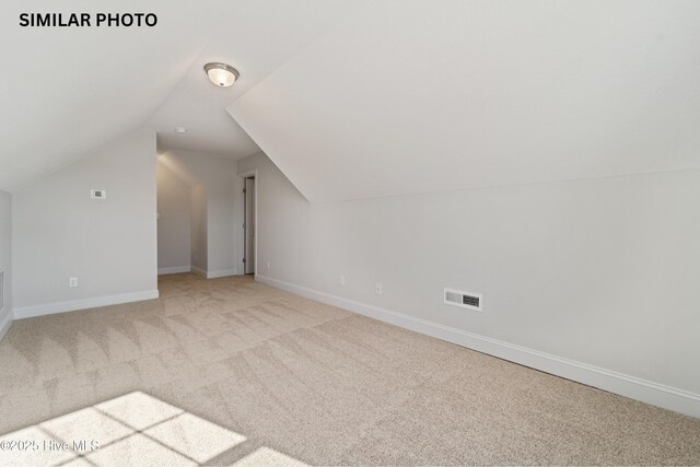 608 Indigo Johnston Dr, Jacksonville, NC 28546 - bonus room featuring visible vents, light colored carpet, baseboards, and lofted ceiling