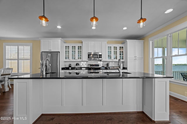 281 Whichard Ln, Chocowinity, NC 27817 - kitchen with stainless steel appliances, dark countertops, ornamental molding, a sink, and white cabinetry