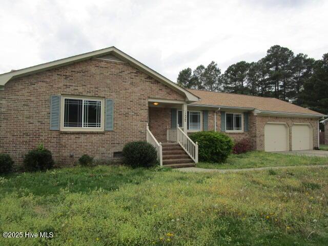 single story home featuring brick siding, crawl space, and a garage