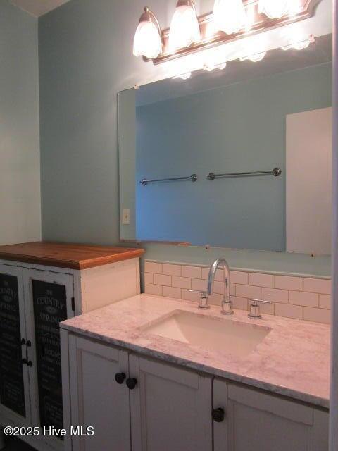 bathroom with vanity and backsplash