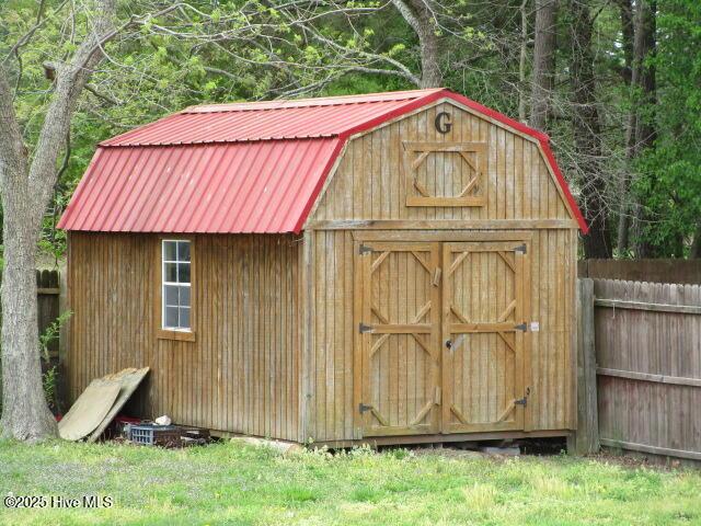 view of shed featuring fence