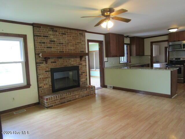 kitchen with visible vents, light wood-style flooring, and stainless steel appliances