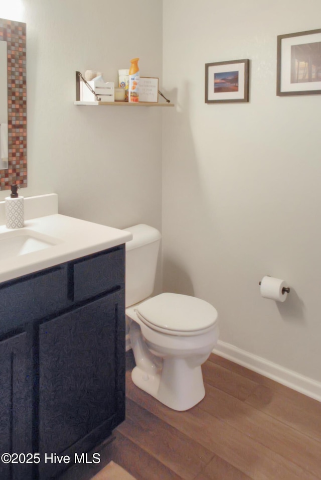 314 Nugget Trl, Elizabeth City, NC 27909 - bathroom with wood finished floors, toilet, vanity, and baseboards