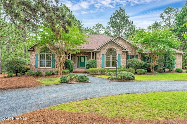 17 Windsong Pl, Whispering Pines, NC 28327 - single story home featuring brick siding and a front lawn