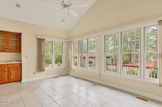17 Windsong Pl, Whispering Pines, NC 28327 - unfurnished sunroom with healthy amount of natural light, tile patterned flooring, and high vaulted ceiling