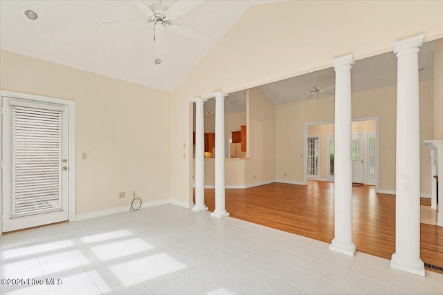 17 Windsong Pl, Whispering Pines, NC 28327 - empty room featuring a ceiling fan, high vaulted ceiling, light tile patterned floors, and decorative columns