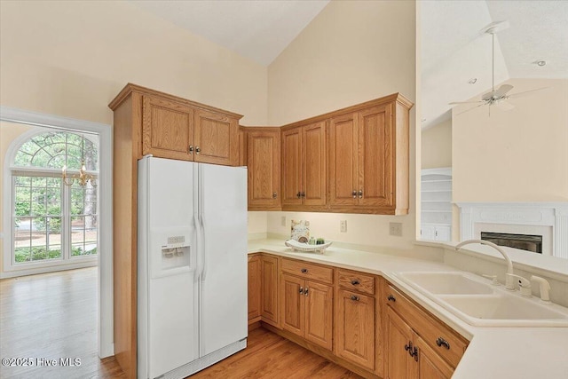 17 Windsong Pl, Whispering Pines, NC 28327 - kitchen with white refrigerator with ice dispenser, high vaulted ceiling, a ceiling fan, light wood finished floors, and light countertops