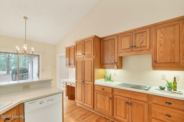 17 Windsong Pl, Whispering Pines, NC 28327 - kitchen with white dishwasher, vaulted ceiling, brown cabinets, electric stovetop, and a chandelier