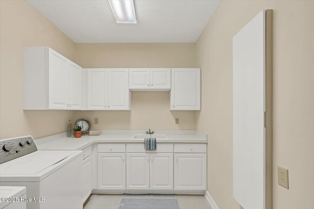 17 Windsong Pl, Whispering Pines, NC 28327 - washroom featuring independent washer and dryer, cabinet space, light tile patterned floors, and a textured ceiling