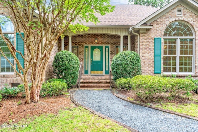 17 Windsong Pl, Whispering Pines, NC 28327 - property entrance with brick siding and roof with shingles