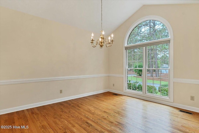 17 Windsong Pl, Whispering Pines, NC 28327 - spare room with a chandelier, lofted ceiling, and wood finished floors