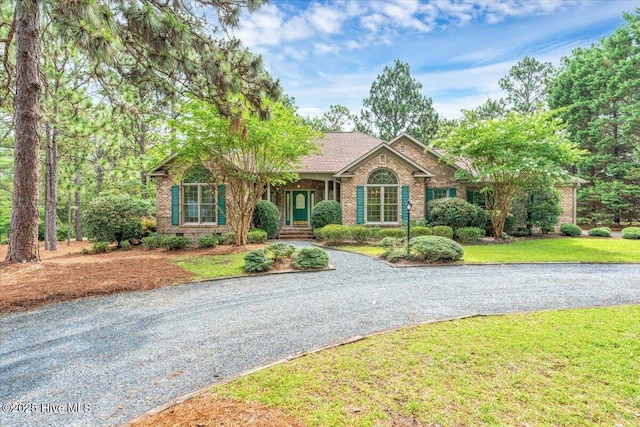 17 Windsong Pl, Whispering Pines, NC 28327 - ranch-style home featuring brick siding, driveway, and a front lawn