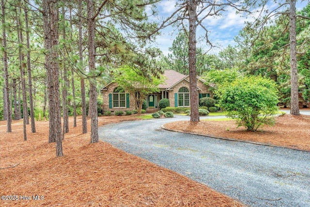 17 Windsong Pl, Whispering Pines, NC 28327 - ranch-style home featuring curved driveway and brick siding