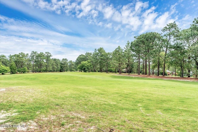 17 Windsong Pl, Whispering Pines, NC 28327 - view of green lawn with view of wooded area and golf course view