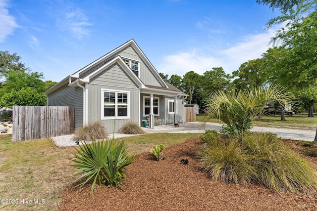 back of property featuring board and batten siding, fence, and a patio area