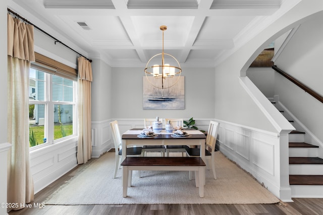 57 N Passerine Path, Hampstead, NC 28443 - dining space with a chandelier, light wood-type flooring, beamed ceiling, coffered ceiling, and stairway