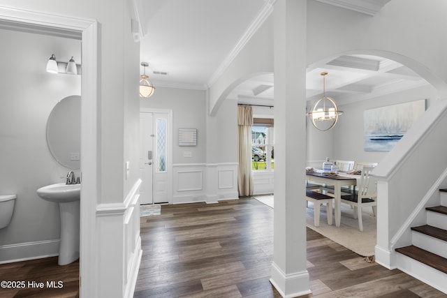 57 N Passerine Path, Hampstead, NC 28443 - foyer featuring arched walkways, ornamental molding, a chandelier, wood finished floors, and coffered ceiling