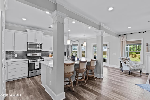 57 N Passerine Path, Hampstead, NC 28443 - kitchen featuring appliances with stainless steel finishes, ornate columns, dark wood finished floors, light countertops, and recessed lighting