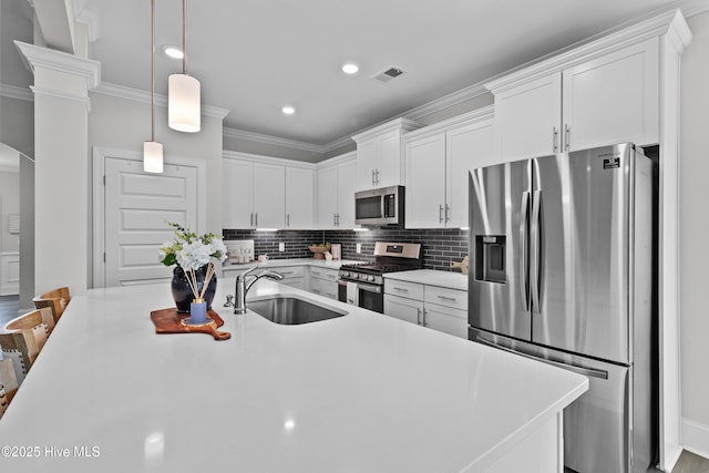 57 N Passerine Path, Hampstead, NC 28443 - kitchen featuring stainless steel appliances, crown molding, light countertops, white cabinetry, and decorative backsplash