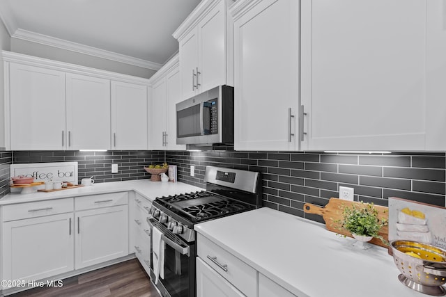 57 N Passerine Path, Hampstead, NC 28443 - kitchen featuring stainless steel appliances, white cabinetry, light countertops, crown molding, and tasteful backsplash
