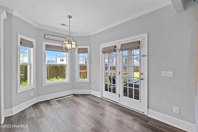 57 N Passerine Path, Hampstead, NC 28443 - unfurnished dining area featuring dark wood finished floors, crown molding, and a chandelier