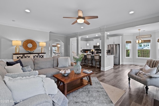 57 N Passerine Path, Hampstead, NC 28443 - living room featuring crown molding, ceiling fan, decorative columns, arched walkways, and dark wood-style floors