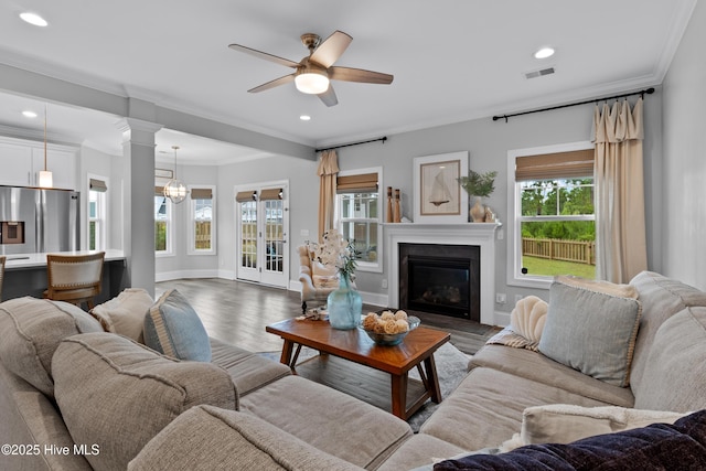 57 N Passerine Path, Hampstead, NC 28443 - living room featuring plenty of natural light, crown molding, a ceiling fan, a glass covered fireplace, and wood finished floors