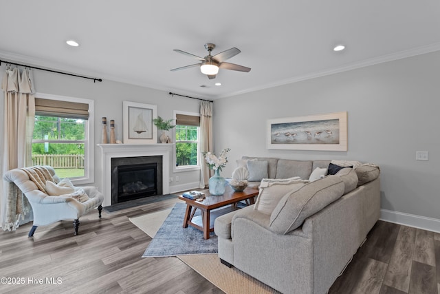 57 N Passerine Path, Hampstead, NC 28443 - living area featuring a ceiling fan, a fireplace with flush hearth, recessed lighting, crown molding, and wood finished floors